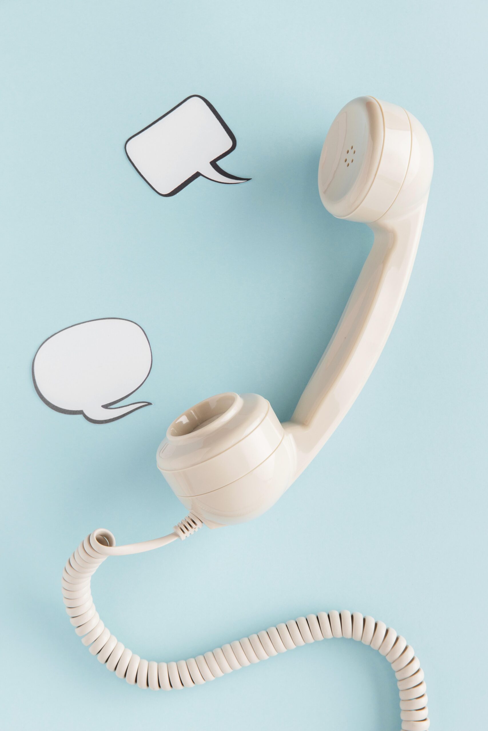 contact retro telephone receiver with chat bubbles